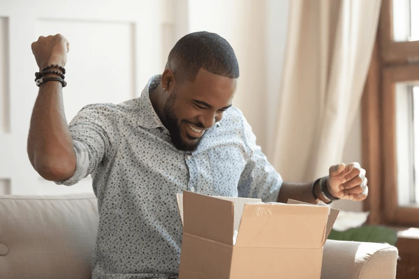 A happy customer receiving a product with a smile.